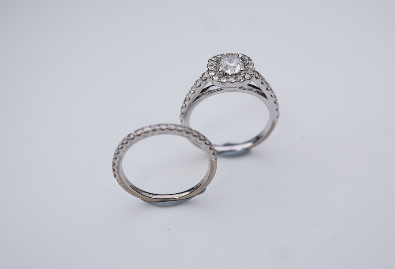 A diamond engagement ring and half eternity ring